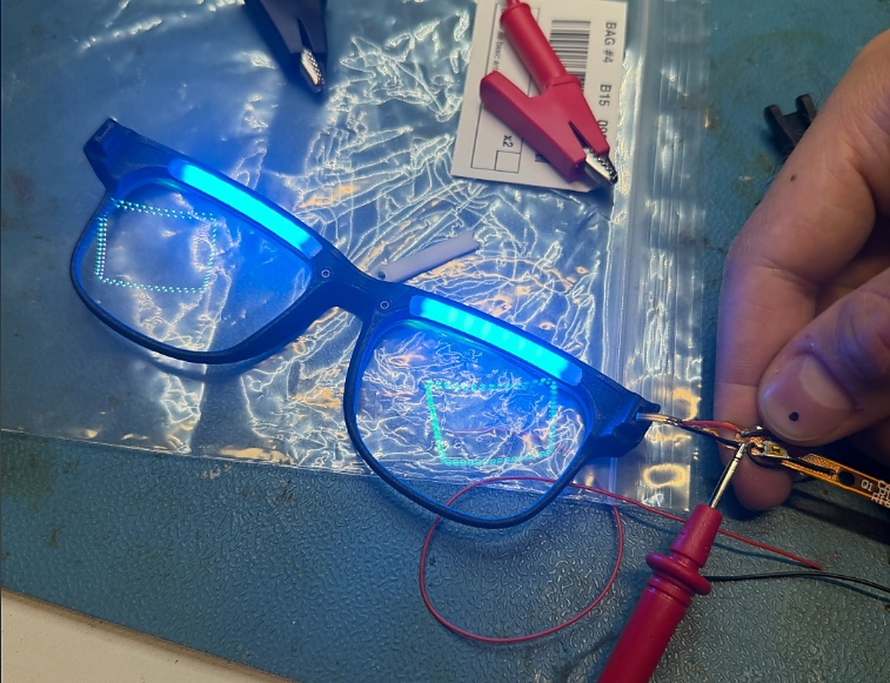 An OptimRise engineering-validation unit powered on during optical testing on a bench.