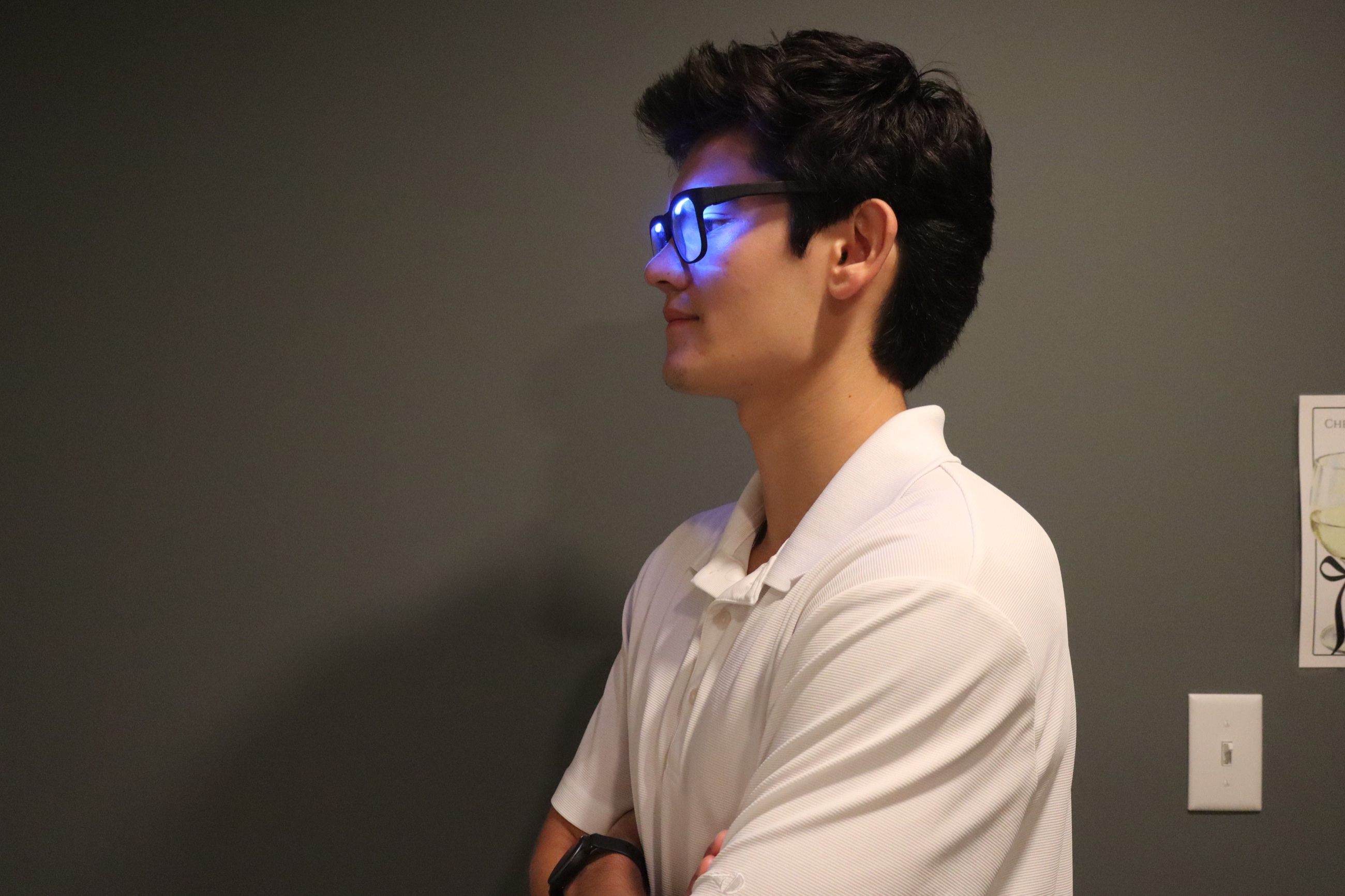 Side profile of a person wearing a powered-on OptimRise engineering-validation prototype.
